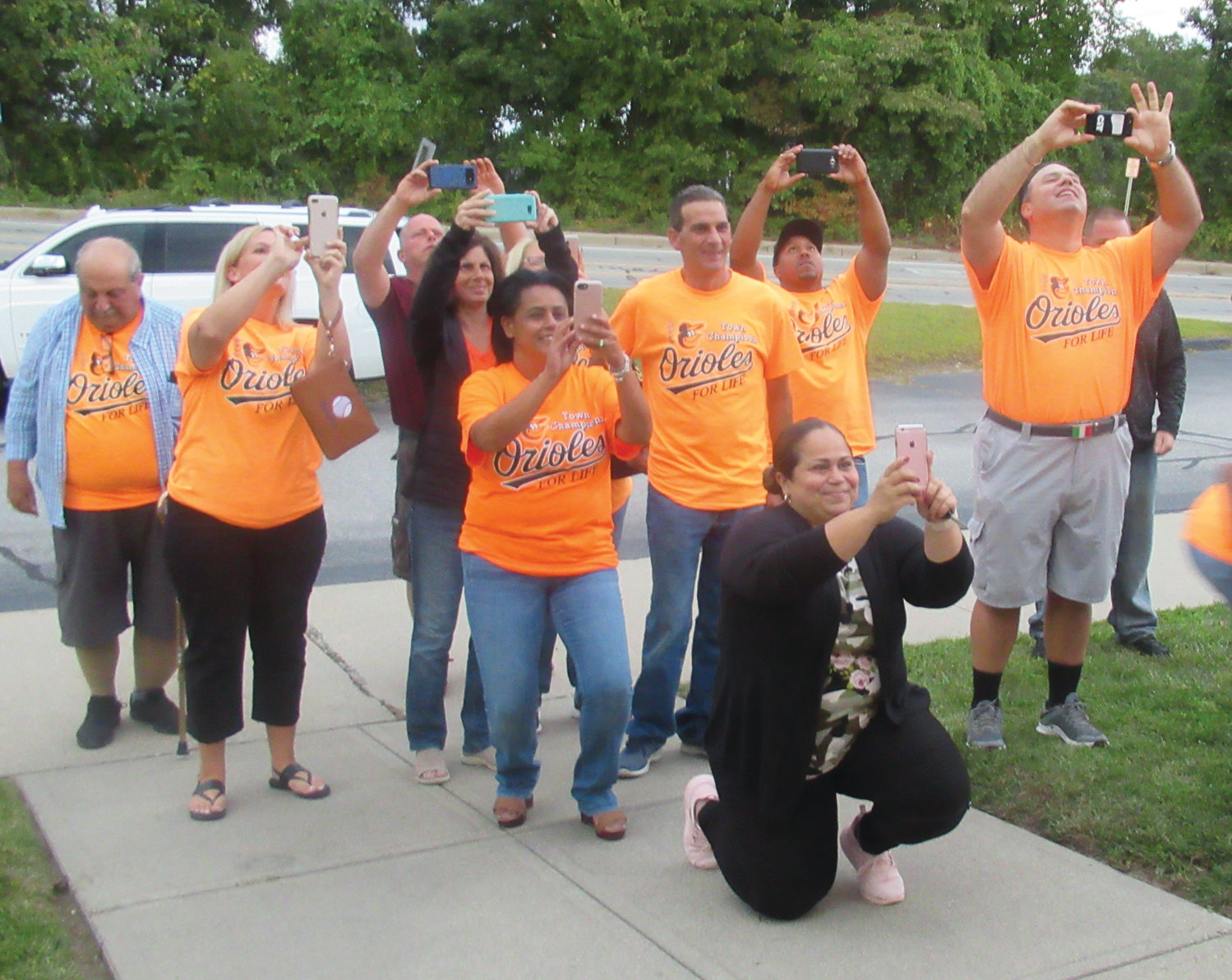 MIGHTY MOMENT: Parents – and even grandparents – of the JLL 2019 Town Champion Orioles enjoy taking pictures after the O’s were honored Monday night by the Town Council inside the Municipal Court House.
