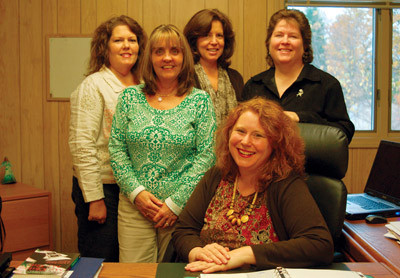 A NEW LEAD: CareNet-Rhode Island's executive director, Rachel Nguyen (center), is surrounded by the rest of the centerâs staff, from left, Joyce Andrade, Maureen Couture, Lisa Neill and Jane Larrabee.