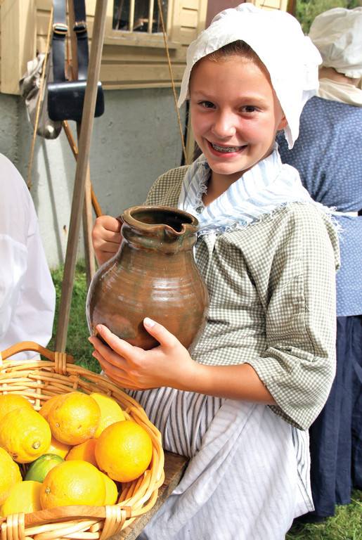 GROWING UP COLONIAL: Abigail Goncalves looks the part while performing chores during the Living History Weekend.