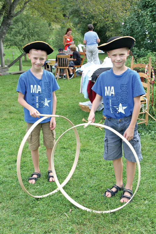 FUN FOR THE WHOLE FAMILY: Jeremy and Jonathan Garant try out the rolling hoops.