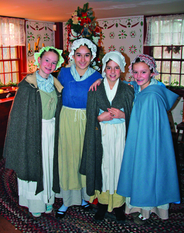 HISTORY IN THE RE-MAKING: The Smith-Appleby House in Smithfield hosted a Colonial holiday event Sunday, complete with volunteers in period costumes, a visit from Santa and hearthside cooking.