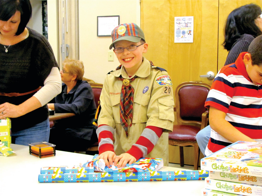 Anthony Andriole, 11, and David DiIorio, 10, who are fifth graders at Barnes Elementary School, tuned out last Thursday night to help the Explorers Post 405 wrap Christmas presents for needy children.