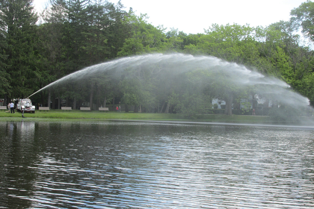 SPRAY AWAY: This spray of water over the pond inside Johnston War Memorial Park came from a 1939 Ahrens-Fox Fire Engine that classic collector Richard “Dick” Shappy brought to the Ocean State Vintage Haulers Show Sunday.