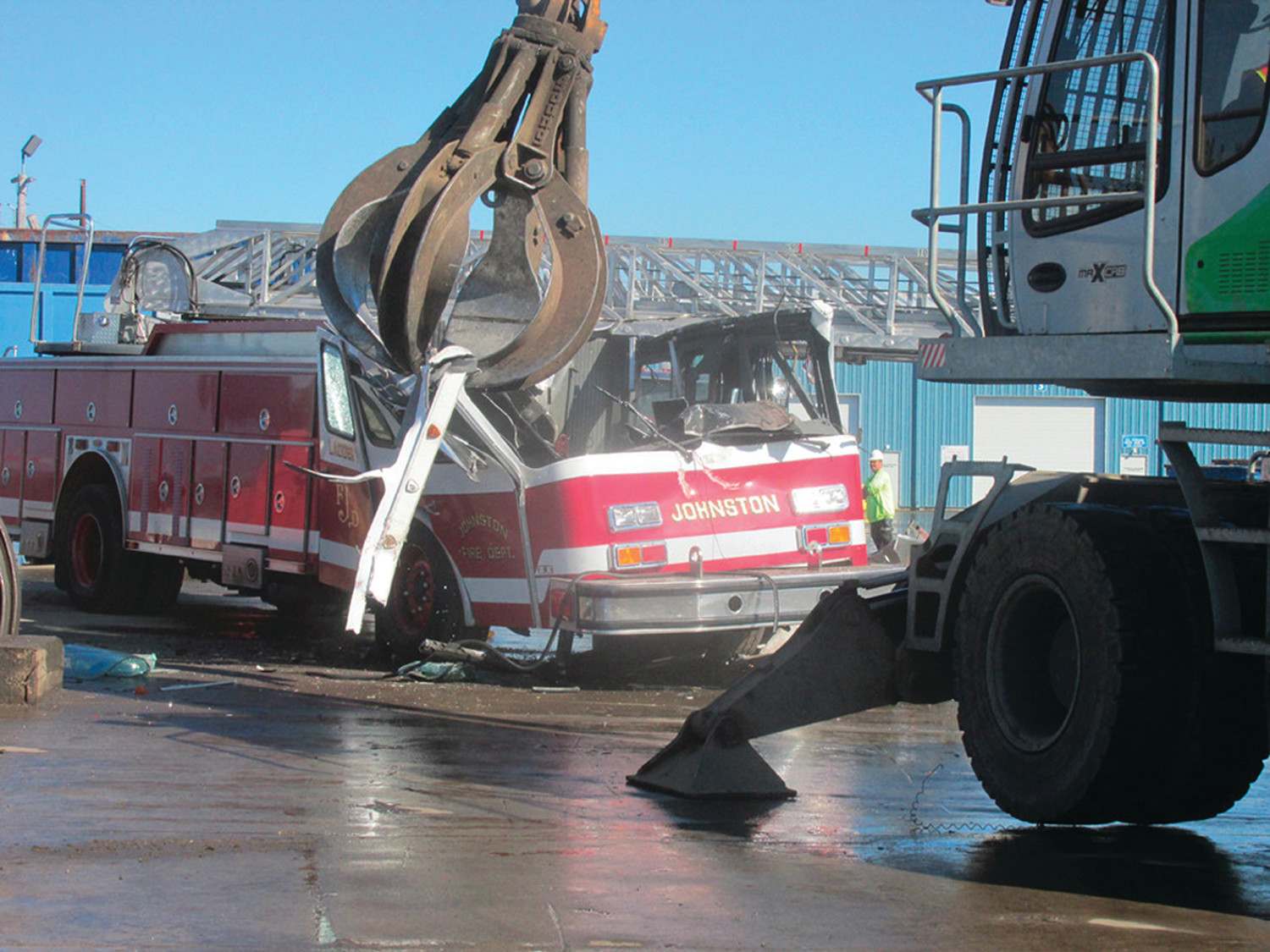 OUT WITH THE OLD: After Sims donated a 2014 Rosenbauer ladder to the town, the company took the Fire Department’s 1991 ladder truck and crushed it at their recycling center.  The company’s recycling operations have come under scrutiny following complaints by neighbors. (Sun Rise photo)