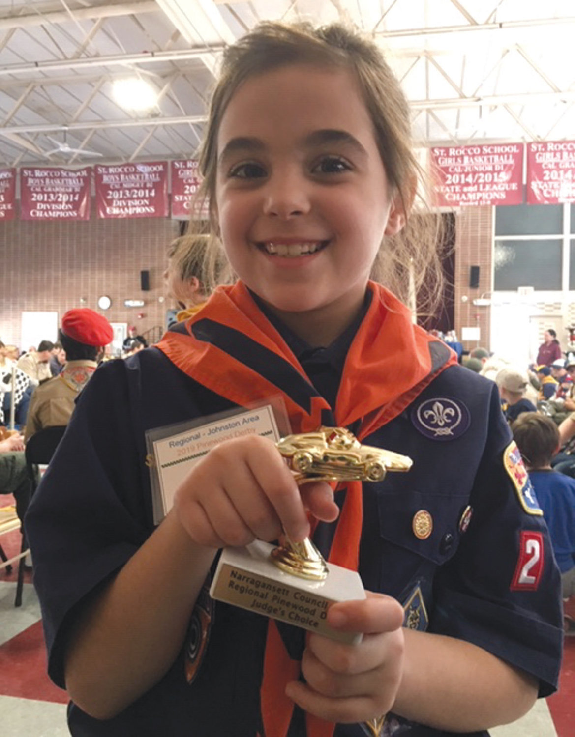 NOTHING BUT HAPPY: Johnston’s Ali LaFazia proudly holds her award for Judge’s Choice in design during the Pinewood Derby Regionals in March. Ali, via her mother Sheri, said her favorite aspects of Boy Scouts include hiking, fishing and camping.