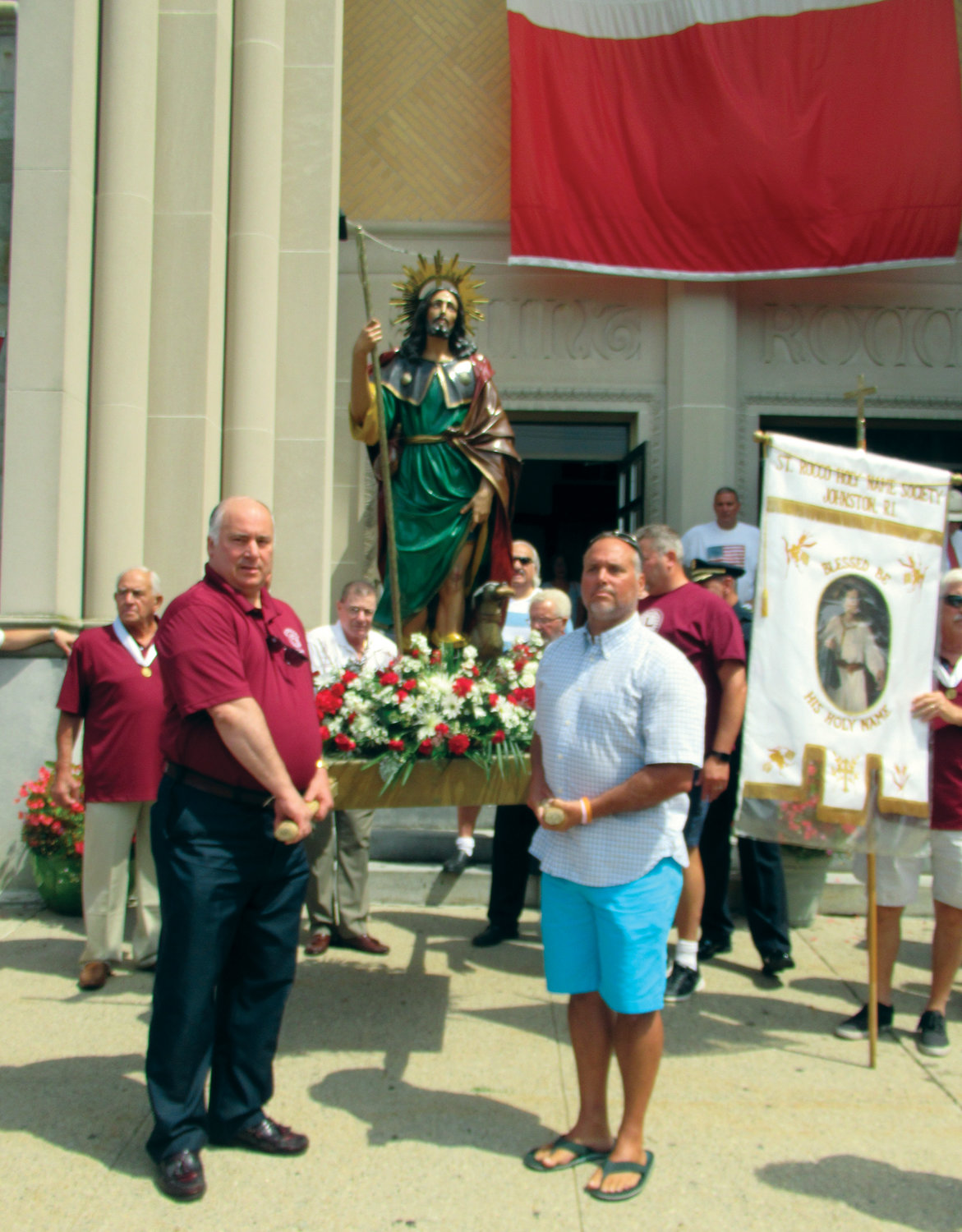 SYMBOL OF FAITH: Members of the Holy Name Society carried the statue of Saint Rocco from the church and into the street for Sunday's annual procession.