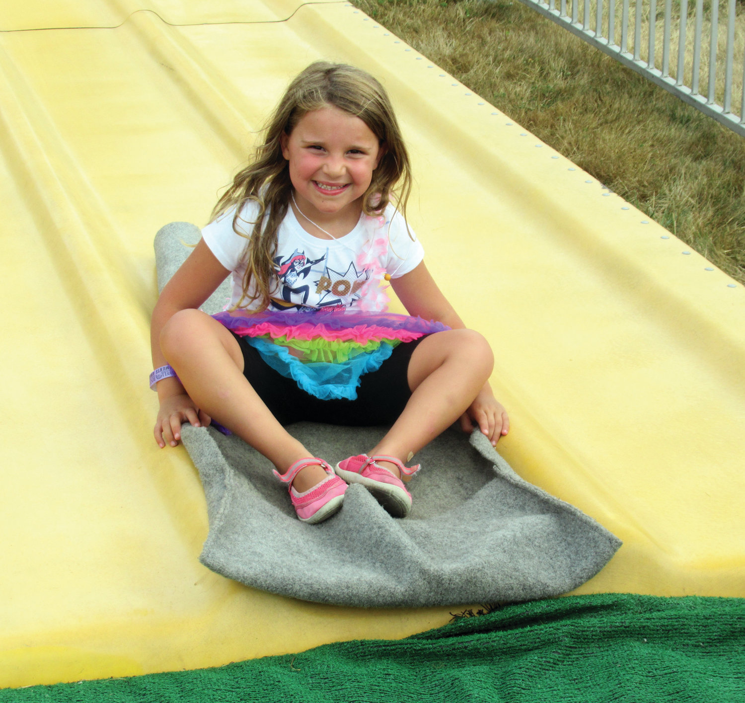 SMILING AND SLIDING: Alexandra Trikoulis is all smiles after finishing yet another run on the popular Rockwell Amusements Fun Slide.