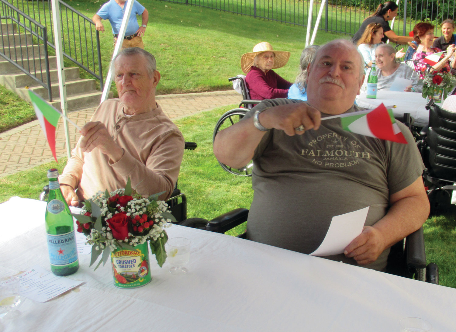 FLAG FUN: These Briarcliffe Manor residents raised – and waved – small Italian flags that were all part of Tuesday’s fun and food-filled Taste of Italy. 