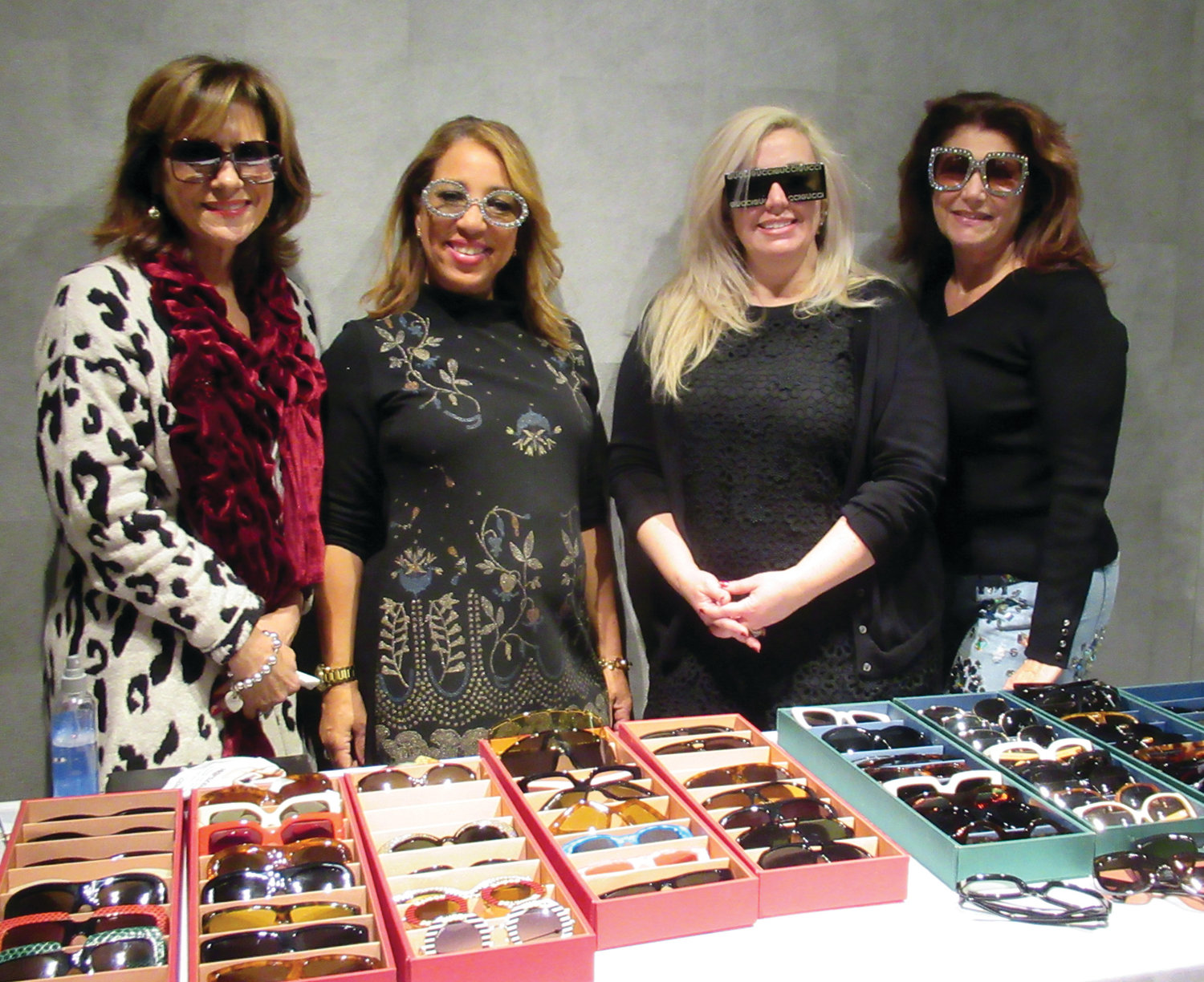 GUCCI GIRLS: Gucci representative Suzette (second left) and ladies like Cynthia Parker, Lynne Diamante and Deb Crossley model the latest look in eye fashion during the recent “Shop for a Cause” in Johnston that was the first event of its kind in New England.