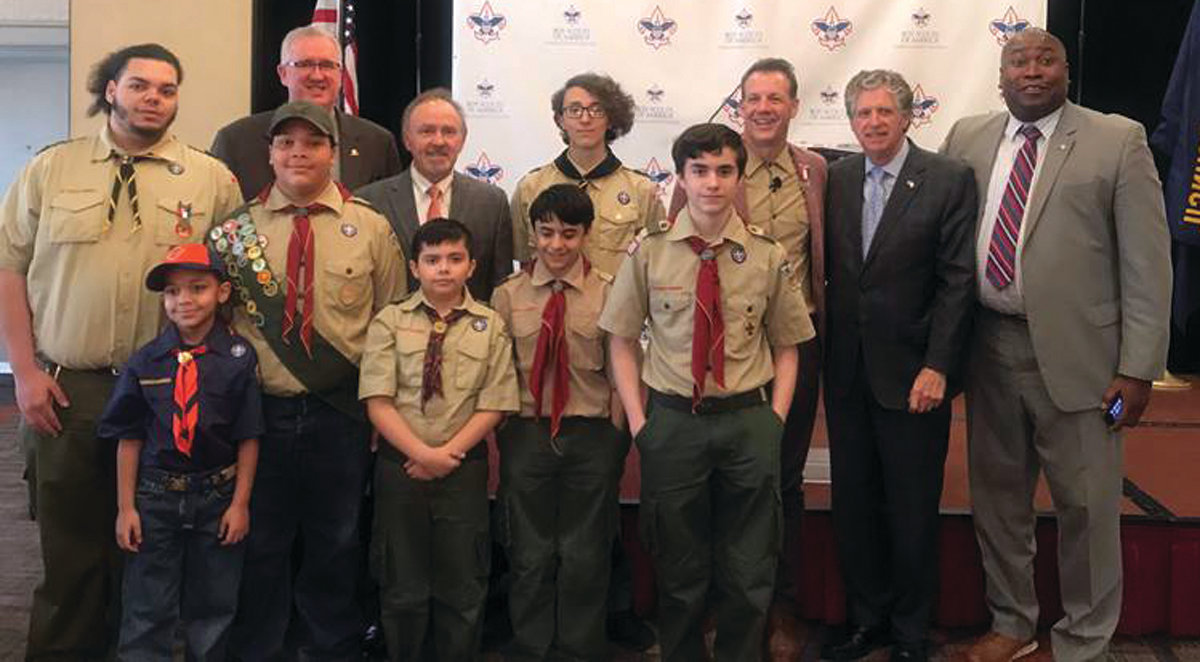 GOOD DEEDS: In the back row, from left to right, Narragansett Council CEO Tim McCandless, President Lloyd Albert, Trent Theroux, Lt. Gov. Dan McKee and Director of the Office of Veterans Affairs Kasim Yarn pose with Scouts from Providence. McKee and Yarn recently led an effort to raise $7,000 for Scouting.