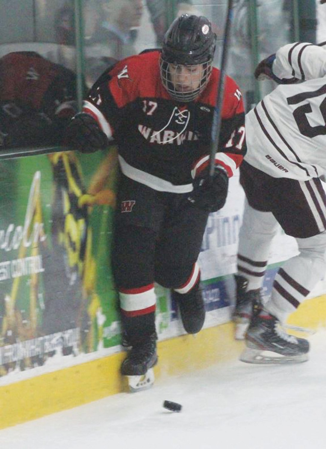 ALONG THE BOARDS: Ryan Barlow battles for the puck.