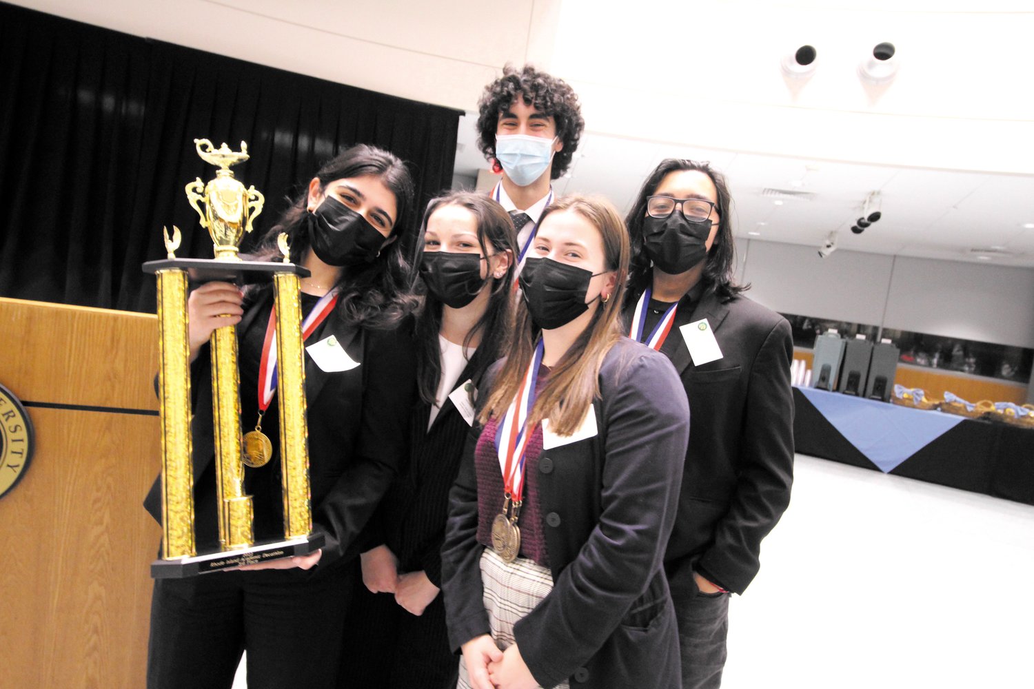 Members of the Cranston West team with the trophy they took home at the 39th Rhode Island Academic Decathlon held Sunday at Bryant University.