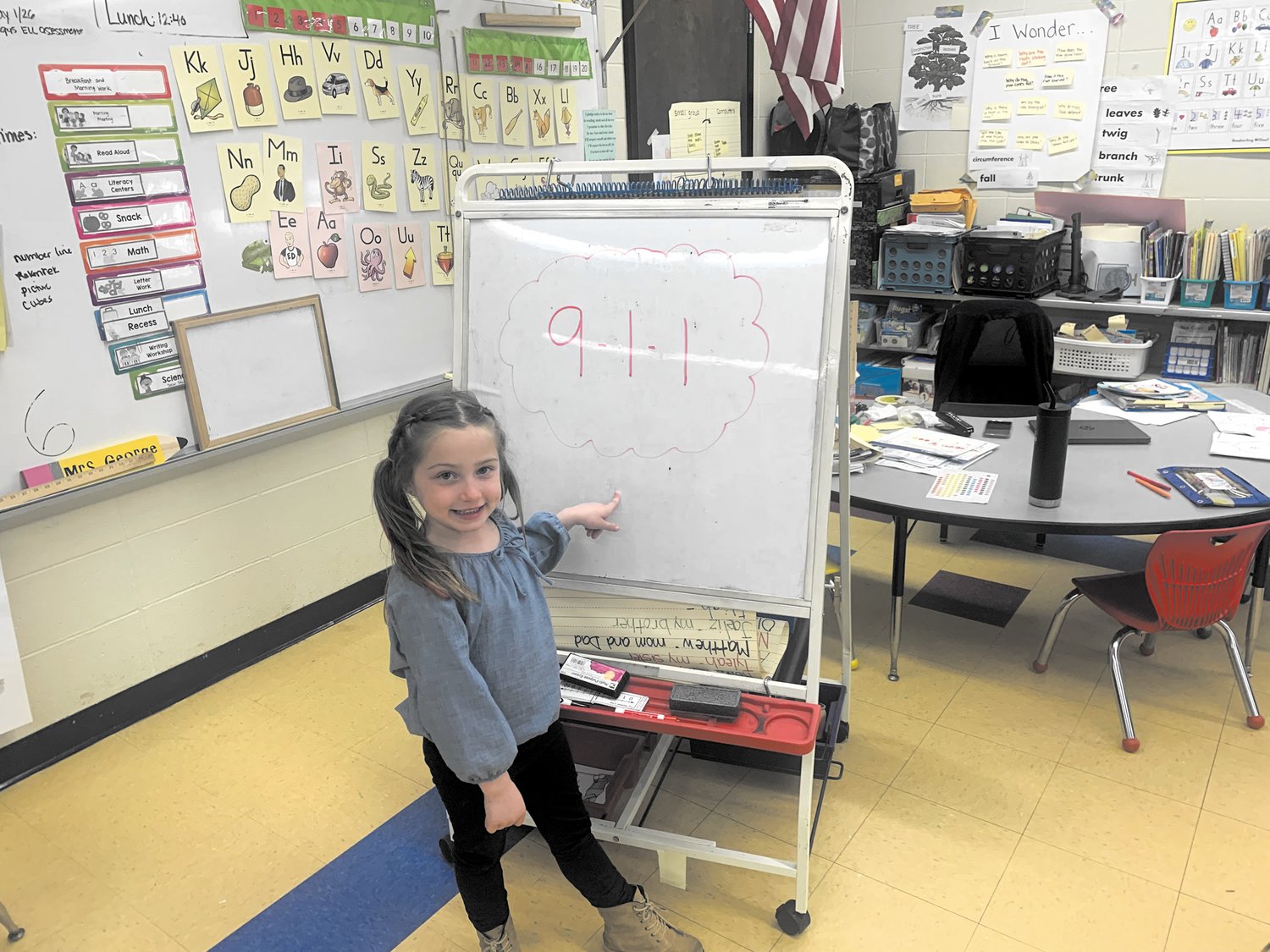 ON THE BOARD: Brooklyn Kraemer points to the code she used to summon help for her grandmother. (Warwick Beacon photo)