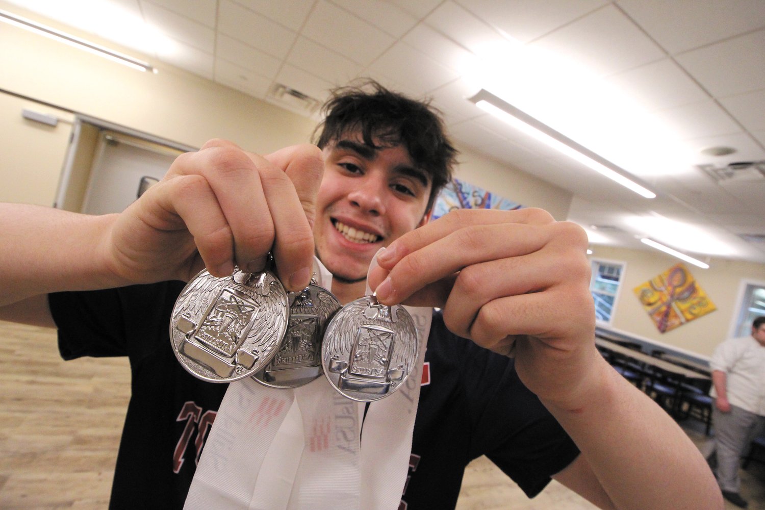 TRIFECTA: Christopher Pires displays the three silver medals he has won over the past three years in the Skills USA internetworking competition. He plans to attend Bryant University where he has been awarded a $27,000 scholarship for four years.