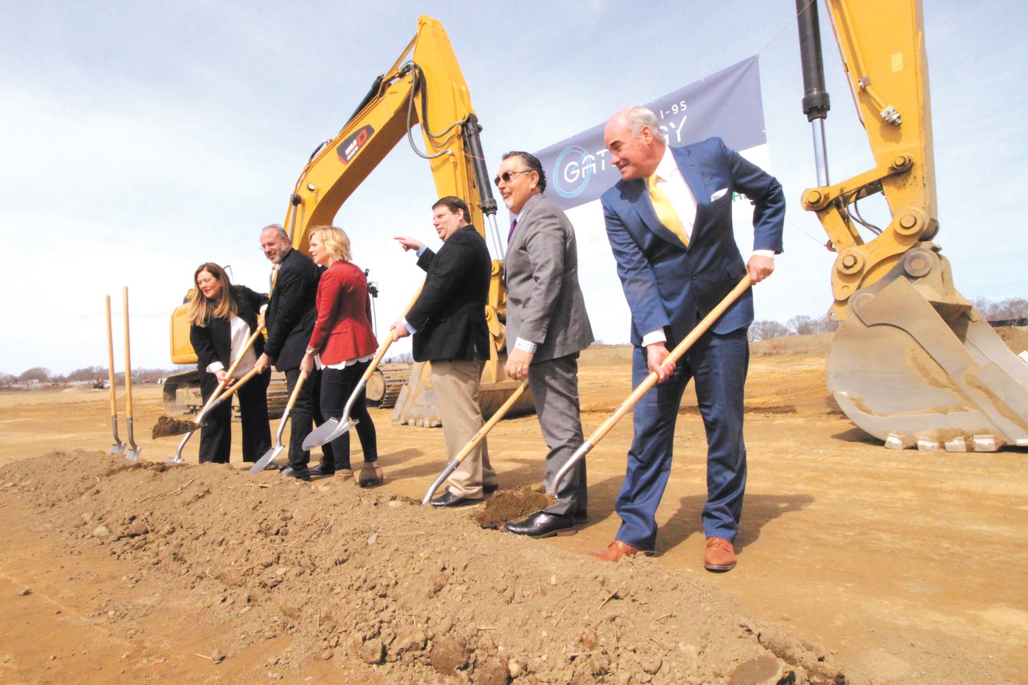 GRAB A SHOVEL: Spotting  there were shovels to spare at Tuesday’s ceremonial groundbreaking of the NorthPoint  489,000 square foot warehouse off Airport Road, Council President Steve McAllister points  to  Ward 1 Councilman Bill Foley to  join the group. According to Natasha Rickel a spokesperson for NorthPoint the project is “currently scheduled to deliver late November.” Pictured with McAllister is Eva Mancuso special advisor to the governor,  Commerce Secretary Stefan Pryor, Regional Vice President for NorthPoint Development Christina Hubacek, Tom Moses,  attorney for NorthPoint and Kelly Coates, president of Carpionato Group that sold the property to NorthPoint. (Warwick Beacon photo)