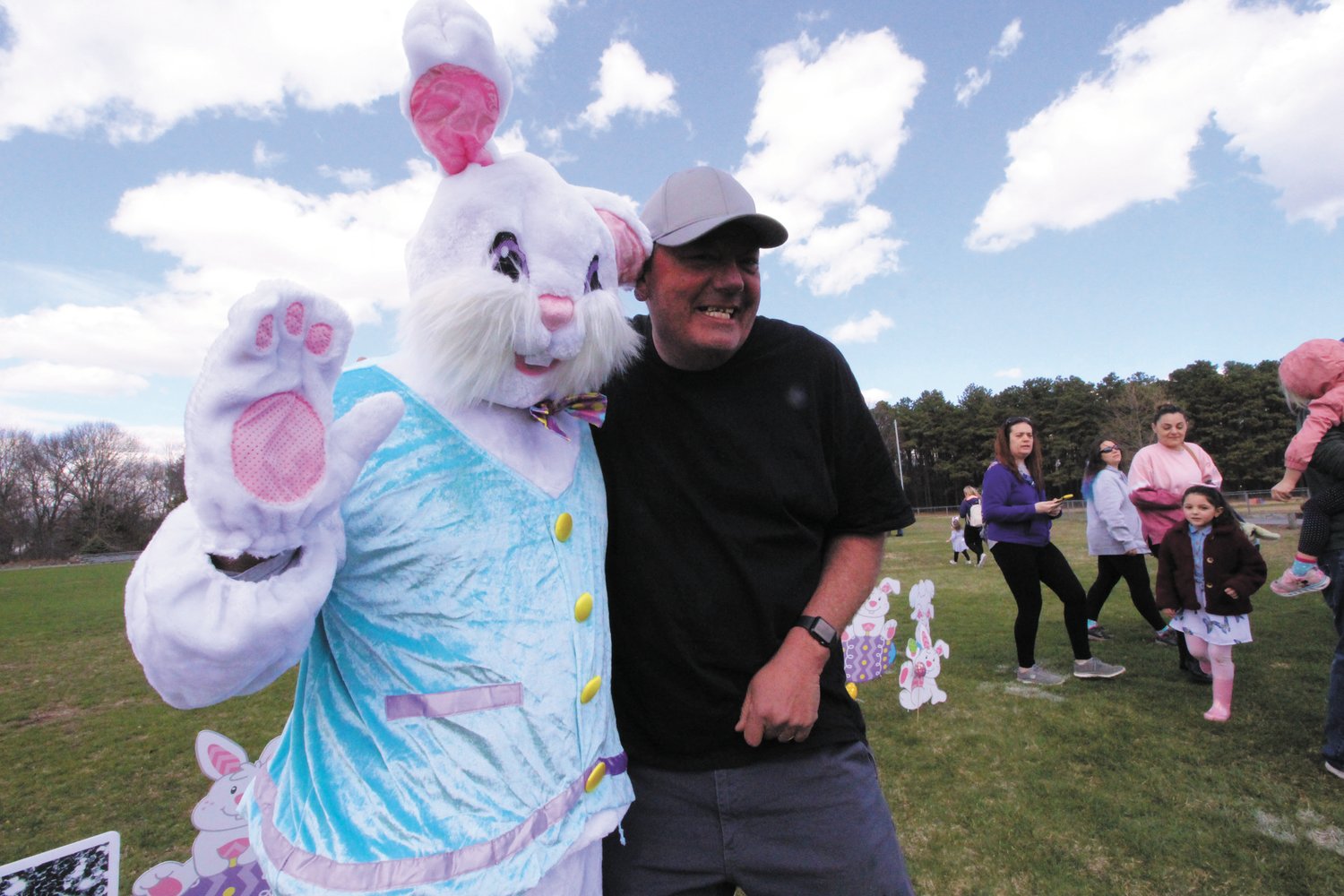 A HUG FOR THE BUNNY: Bill Court , who has earned the name of “dancing dad” at the studio for all the handiwork he does greets the Easter bunny.  