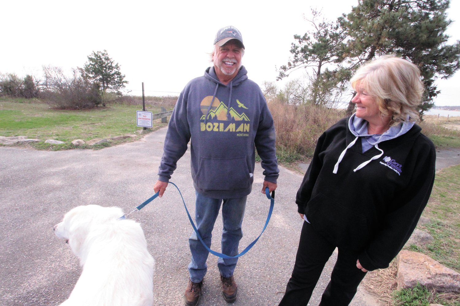 THEY’VE SEEN THE CHANGES:  Cindey and Steve Uralowich who routinely walk their dog Montana at the park have noticed the loss of beach sand and the number of dead trees.