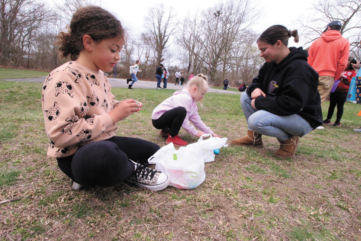 HUNTING FOR NUMBERS: Sophie Hazelwood-Chase and Emily MacInosh look for numbers in the eggs they retrieved as Paige McCoy looks on.   