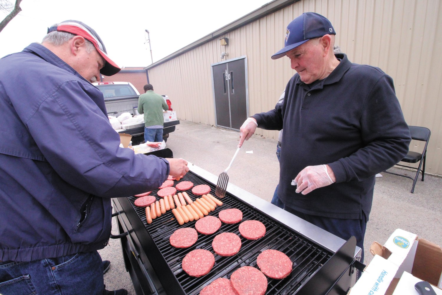LUNCH TOO: The Knights of Columbus team manned the grill for the Oaklawn Beach egg hunt on Saturday.