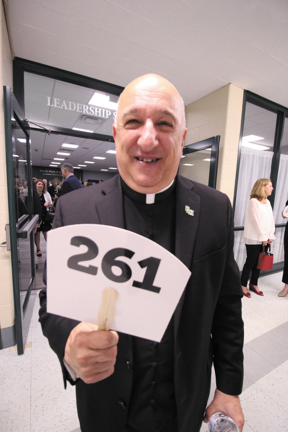 PRAYERS AND BIDS: Fr. Robert Marciano, pastor of St, Kevin and president of Bishop Hendricken High School said prayers and bid at the school’s Epoch held Saturday.