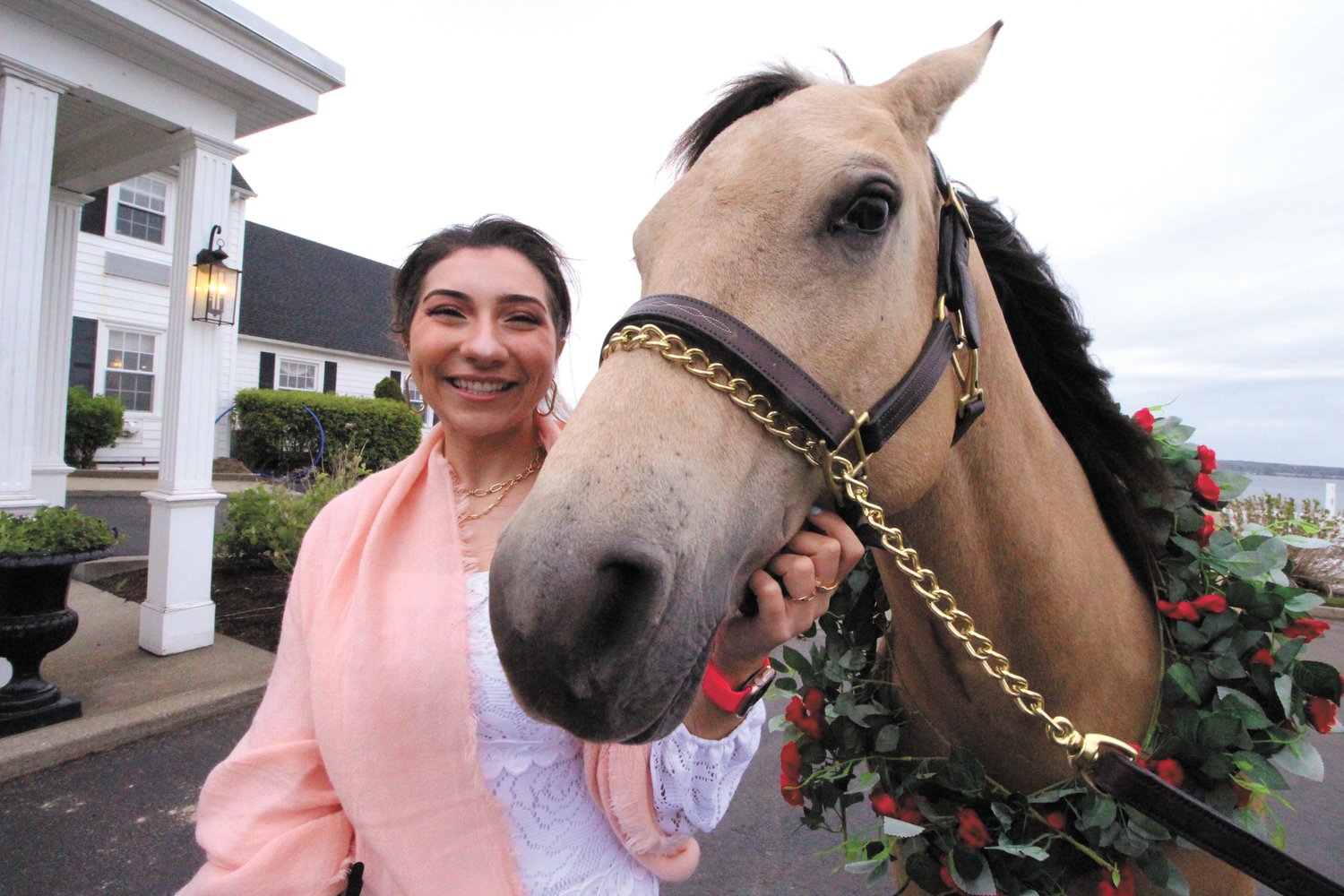 THEY MAKE A COUPLE: Amanda Day, court felony advocate at EBC, makes friends with one of two horses that greeted those attending the Run for the Roses.