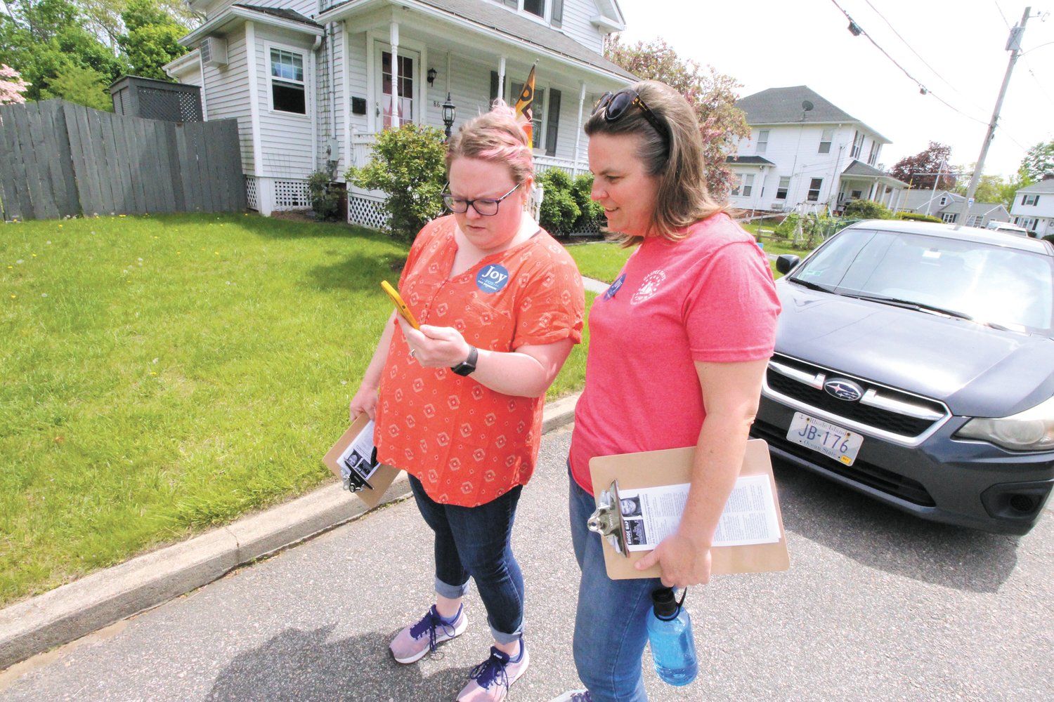 NEIGHBORHOOD STRATEGY:  Katie Hall and Congressional candidate Joy Fox look over a list of Norwood registered Democrats prior to a tour of the Warwick neighborhood Saturday afternoon.