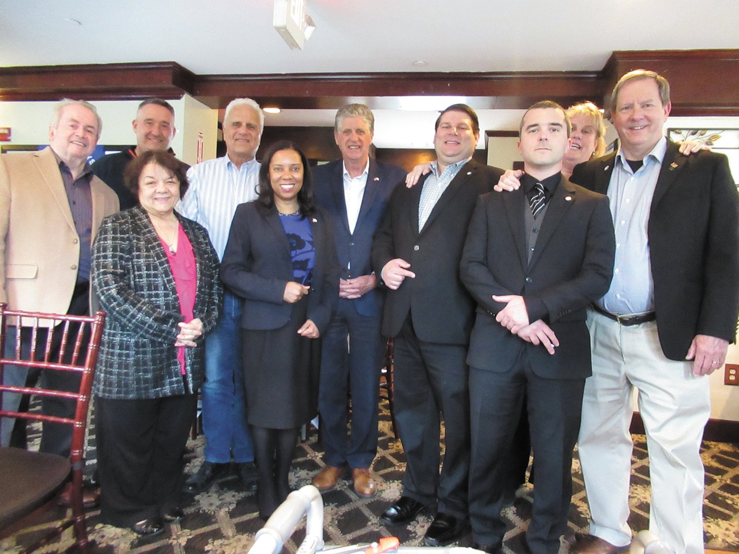LINKED LEADERS: Gov. Dan McKee and Lt. Gov. Sabina Matos are joined by Warwick City Council members James McElroy, Timothy Howe, Donna Travis, Steve McAllister, Anthony Sinapi, Democratic Party Chair Kim Wineman and William Foley during last week’s “Beer with the Governor” event at O’Rourke’s Bar & Grill in Pawtuxet Village. (Warwick Beacon photos by Pete Fontaine)