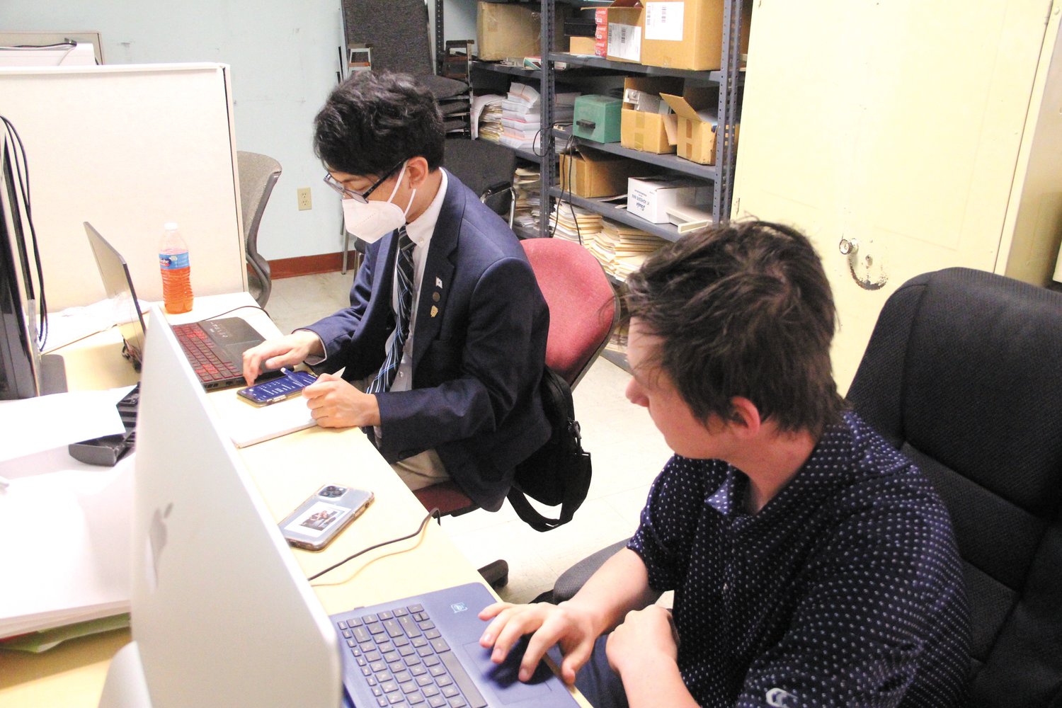 AT WORK: Hendricken seniors Aiden Cahill and Daniel Franchetti collaborate on a story about the senior experience. (Warwick Beacon photo)
