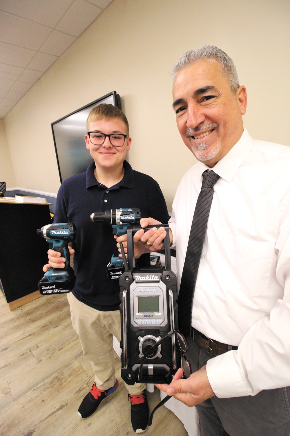 JUST WHAT HE CAN USE: Joseph LeBelle was delighted to receive electrical tools, donated by Netcoh Sales from Wayne Pimental who ran Thursday’s program at the Tides Restaurant at the Warwick Area Career and Technical Center.
