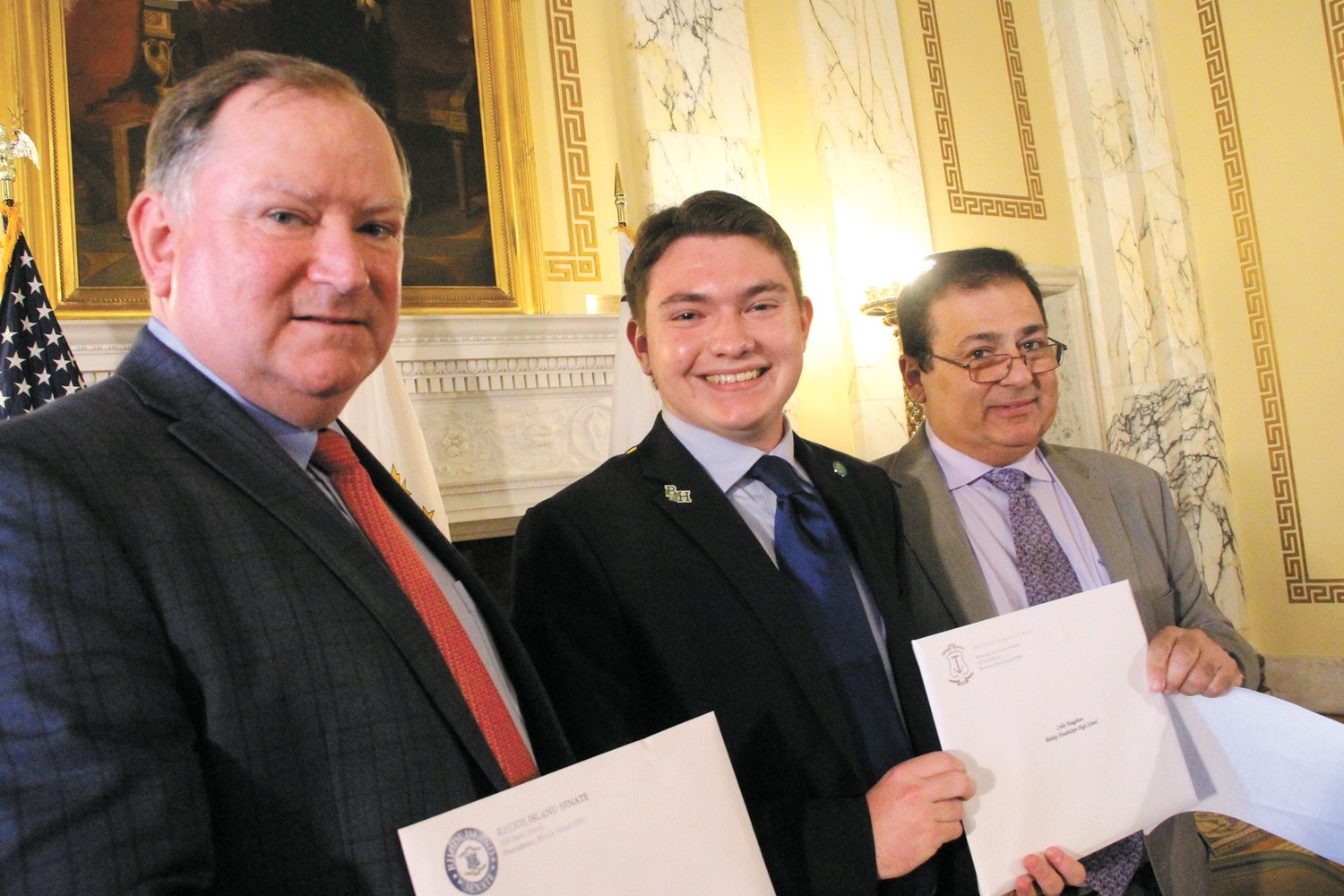A BREAK FROM SCHOOL & SENIOR EXPERIENCE: Colin Naughton, who won a gold medal for his speech in the 2022 RI Academic Decathlon was one of nine senior recipients to receive a $500 scholarship from House Speaker K. Joseph Shekarci in ceremonies May 17 at the State House. Senate Majority Leader Michael McCaffrey, left, also presented Naughton with a citation. (Warwick Beacon photo)