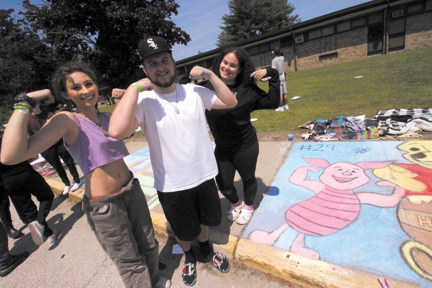 PUTTING MUSCLE IN THEIR WORK: Cailyn McNamar, JT Robertson  and Model Cabreja stand over their completed panel.