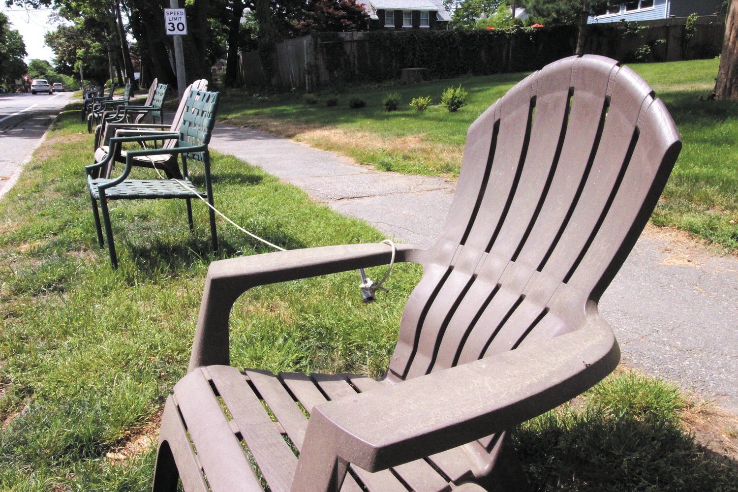 LOCKED IN SEATING: In anticipation of Saturday’s Gaspee Days parade, chairs started appearing along Narragansett Parkway Tuesday. Topping it off, these chairs were secured with a lock.  (Warwick Beacon photo)
