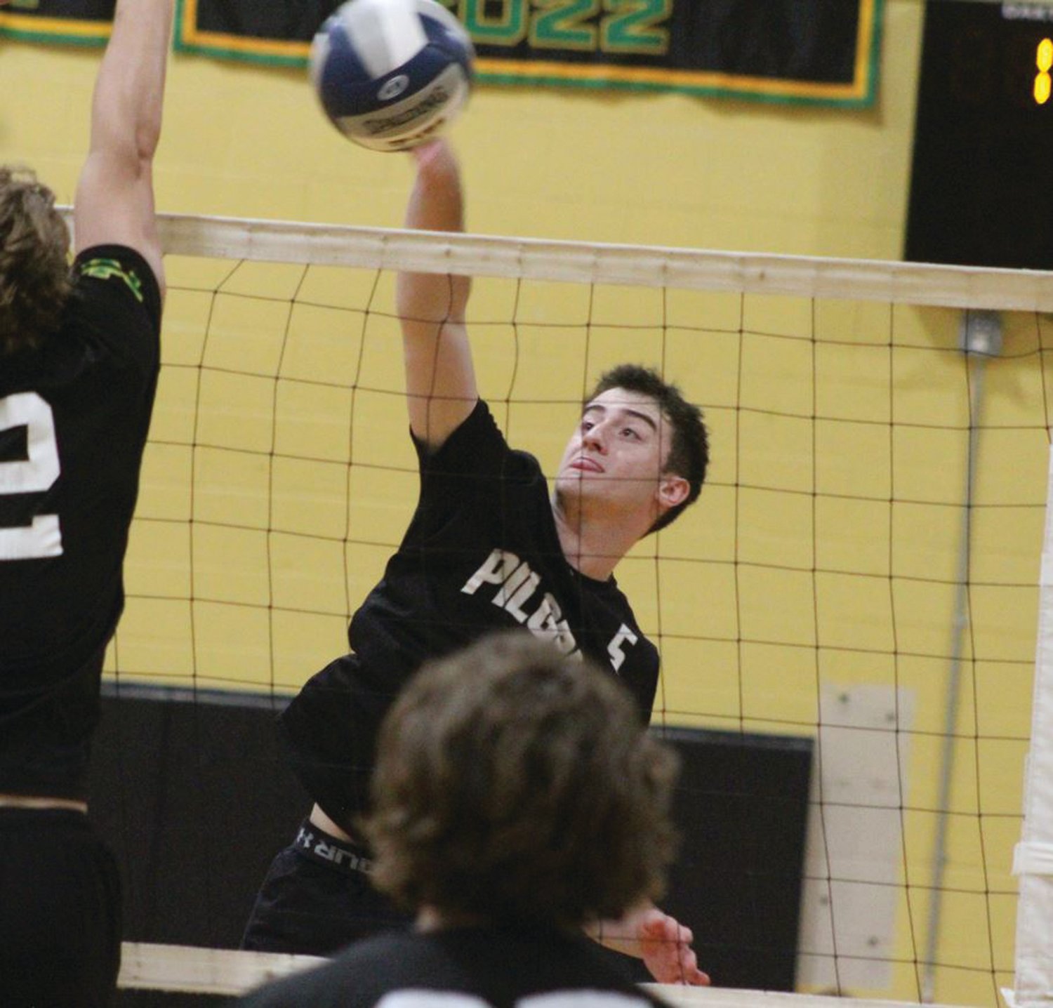 UP AND OVER: Benjamin Conti sends the ball over the net. (Warwick Beacon Photo)