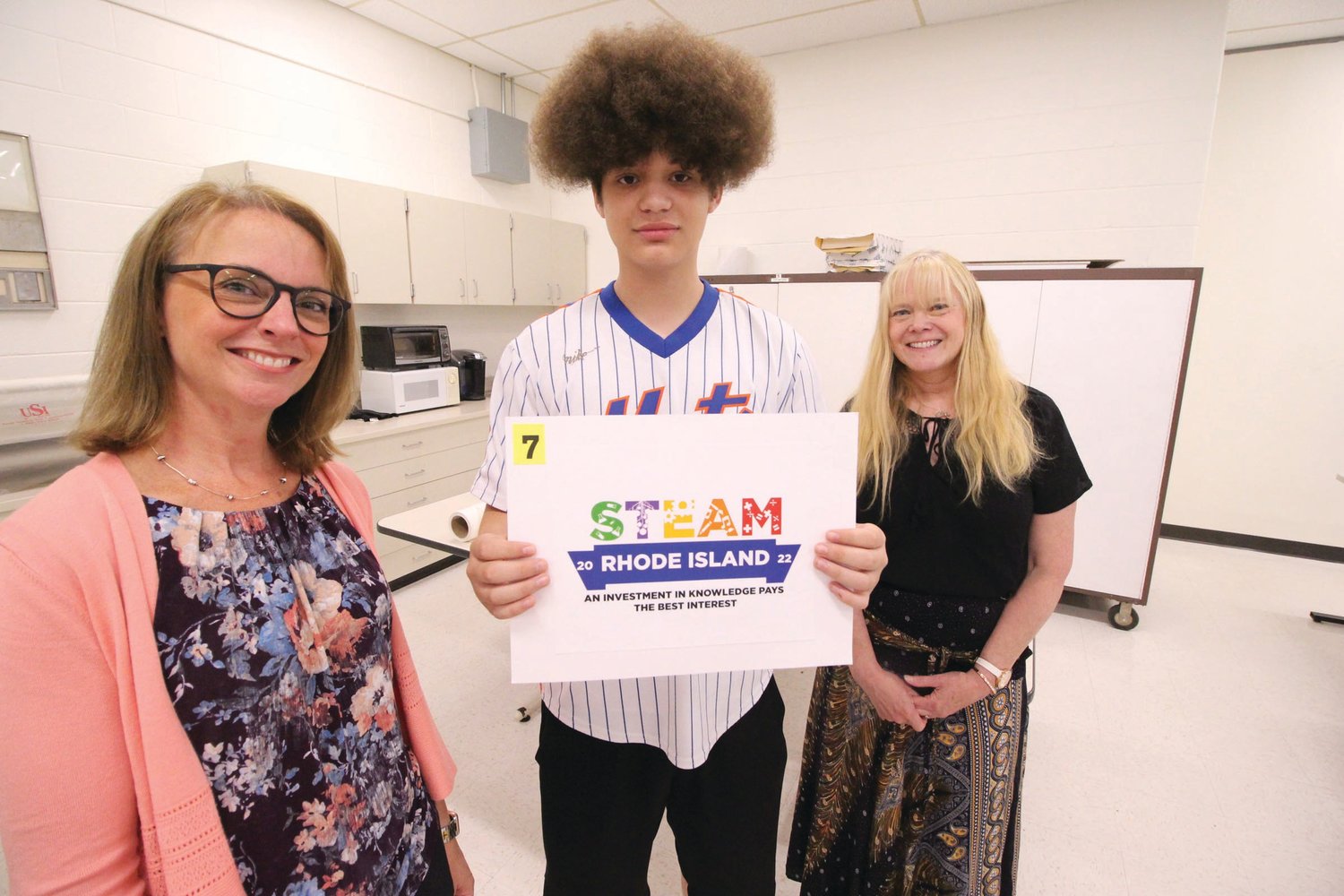 WINNING LOGO: Toll Gate sophomore and Warwick Area Career and Technical Center graphics arts student Jonah Townsend is flanked by Carolyn Higgins, left, STEAM specialist at the office of instruction, assessment and curriculum at the Department of Education and graphics art teacher Jann Rogers-Gartner. Townsend is the winner of the Rhode Island Department of Education STEAM Logo Design Contest. (Warwick Beacon photo)