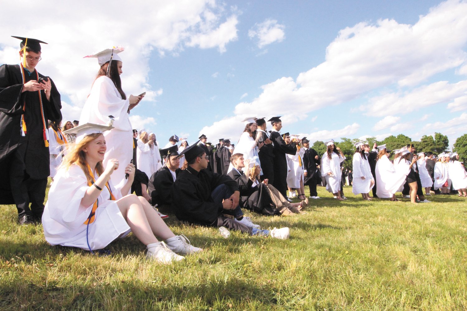 WAITING IT OUT: Pilgrim seniors line up in preparation for the procession and the beginning of the ceremony.