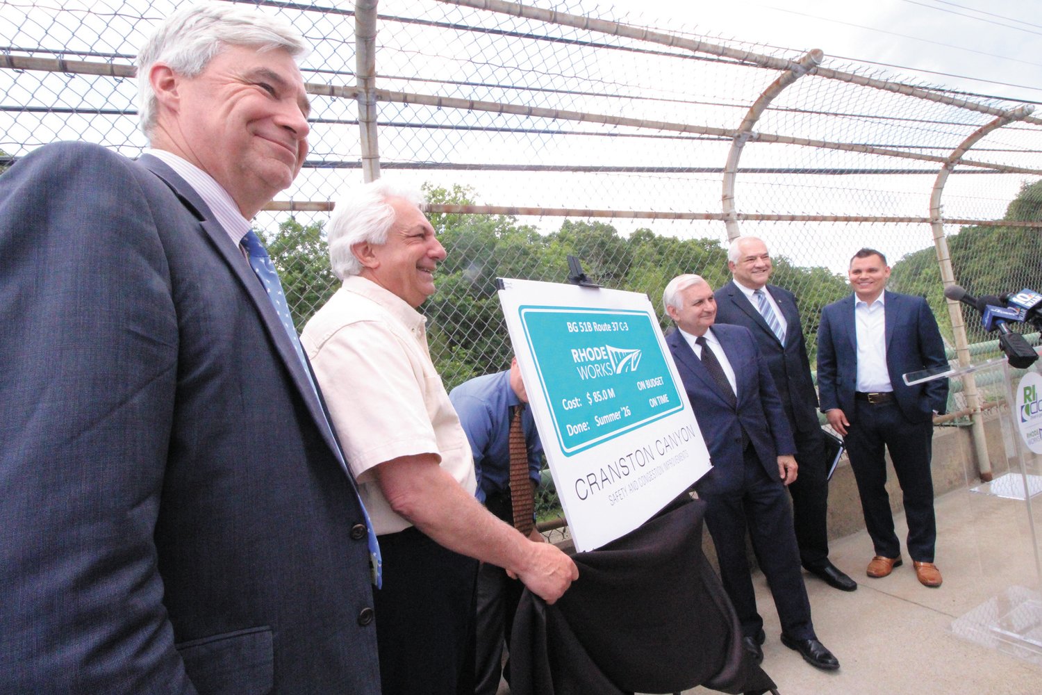 SIGNS OF WORK TO COME: On the Phenix Ave. bridge in Cranston overlooking Route 295, state and federal officials gathered Friday to announce the $85 million Cranston Canyon Project. Pictured are Senator Sheldon Whitehouse, DOT Director Peter Alviti, Senator Jack Reed, Carlos Machado, district director of the U. S. Department of Transportation Federal Highway Administration and Rep. Brandon Potter of Cranston. (Beacon photo)