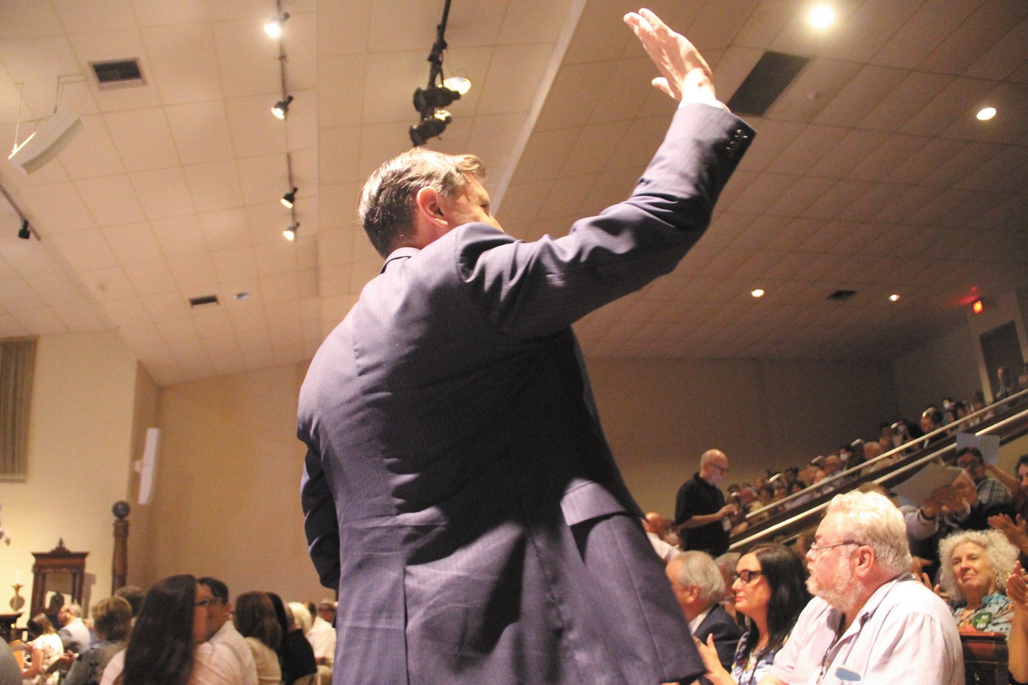 WAVING IN APPRECIATION: Seth Magaziner rises to thank convention delegates following the vote giving him the party’s nomination for the Second Congressional District.