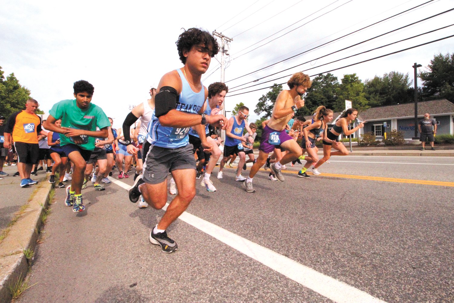 Runners in the St. Mary’s Feast Society 5K Road Race held Sunday take off after Mayor Ken Hopkins gave the countdown. (Warwick Beacon photos)