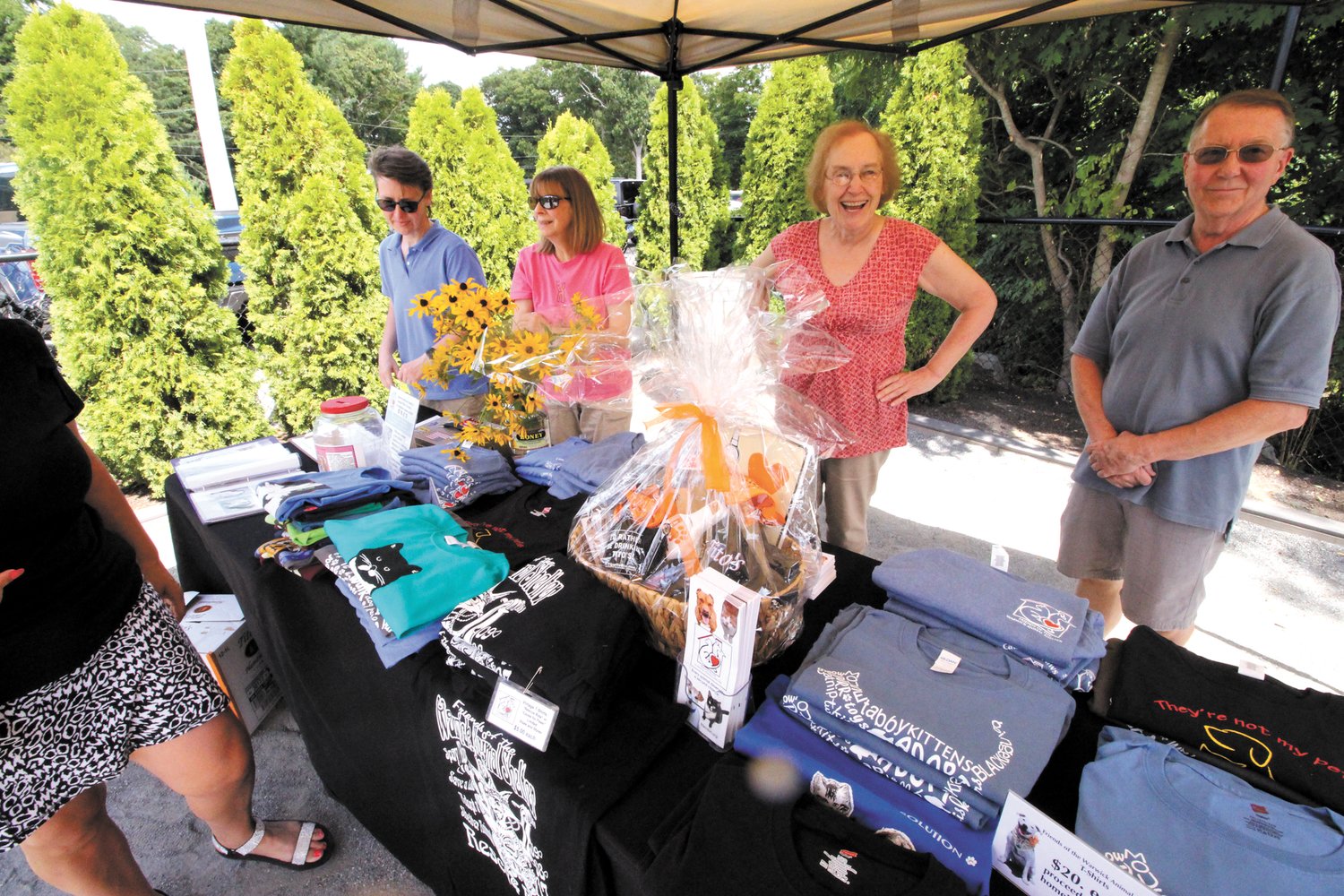 LOTS TO PICK FROM: In a the shade of a tent, Friends of the Warwick Animal Shelter signed up volunteers, sold items to benefit the organization and collected raffle tickets.