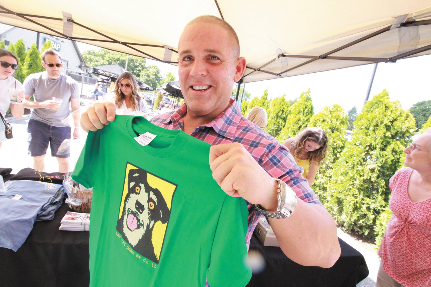 NOW THAT’S A GOOD ONE: Dave DelRossi, who came up with and coordinated Tito’s & Treats at the Trap, models one of the T-shirts the Friends of the Warwick Animal Shelter sold at the event.