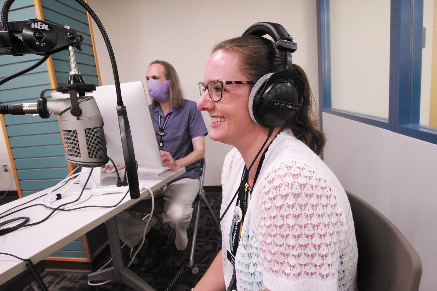 A DRY RUN: Wil Gregersen is at the controls as he gives library co-worker Tanisha Sampson a feel for what it will be like when she is a contestant on the upcoming Warwick Radio Online historic cemeteries podcast. (Warwick Beacon photo)