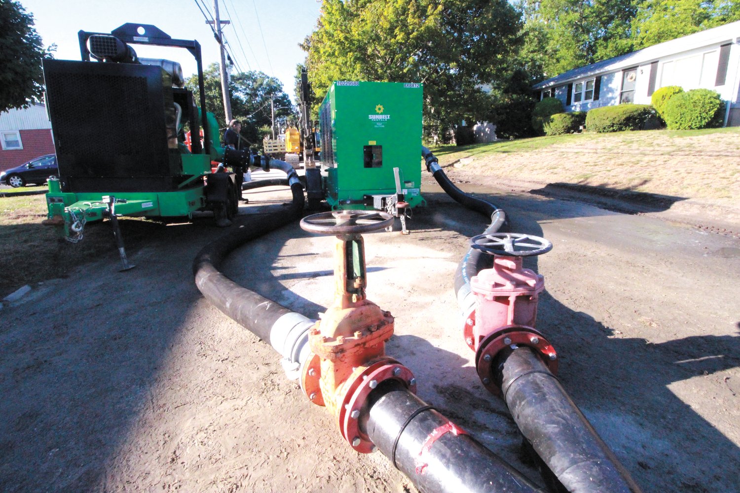 SHUTTING OFF THE LEAK: With a bypass to the broken pipe in place, the site of the break Wednesday morning was in stark contrast to the river of wastewater that defined the scene as pictured Monday night, above. (Warwick Beacon photo)