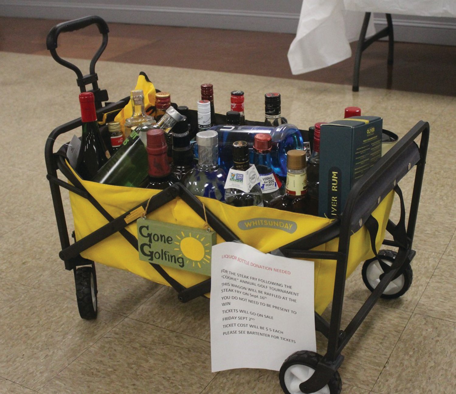 GREAT GIFT: Tri-City Elks members Noel and Deb Petisce donated this wagon that was filled with 23 different bottles that will boost the profit of the 2nd Annual Albert “Cookie” Memorial Golf Tournament.