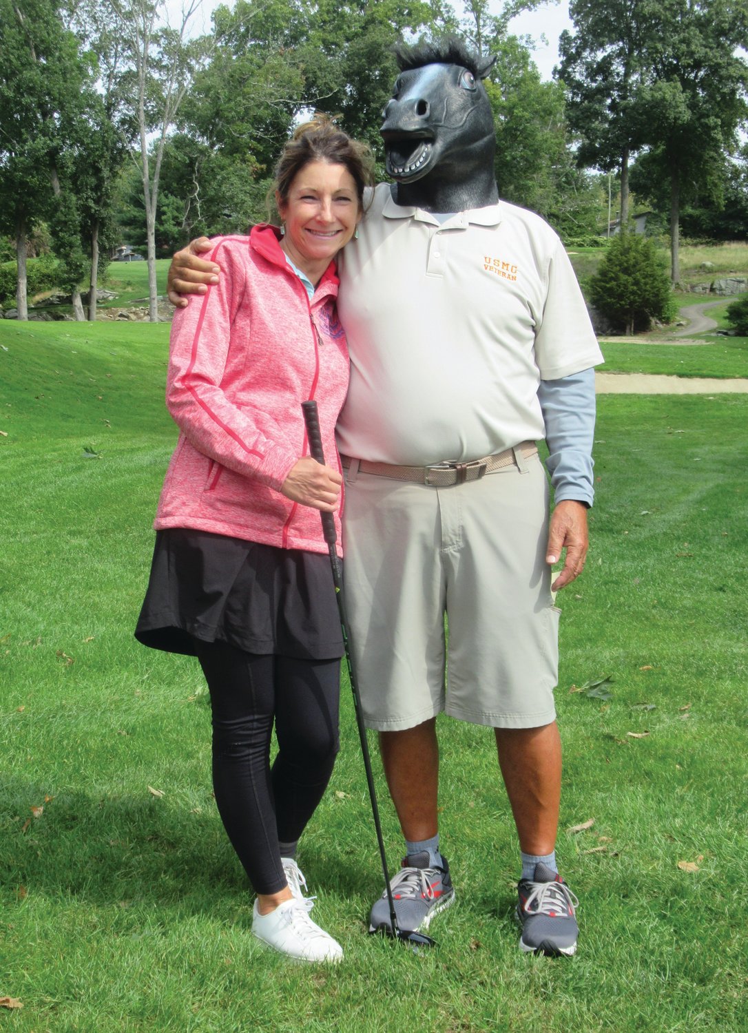 WHO’S WHO? Tracy Uriati, a member of GCC, is joined by the “Mystery Masked Man” prior to a recent golf go-round. The latter will also make an appearance in the Nov. 11 Veterans Day Tournament.
