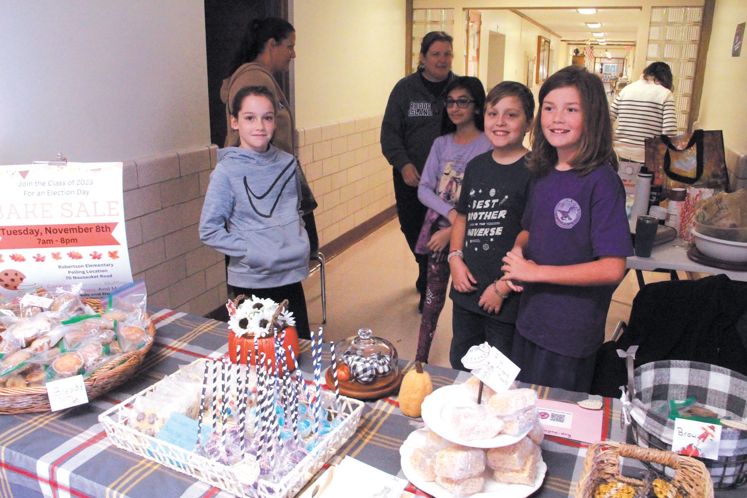 JUST WANT VOTERS WANTED: Robertson School fifth graders with the aid of their mothers set up a table of baked goods and candy in the corridor leading to the poll. Items sold for one dollar with the money going to the class for protects they are planning. Seen here from left are Adelynn Yates, Olyvia Giles, Patrick Sweeney and Tyler Parkhurst.