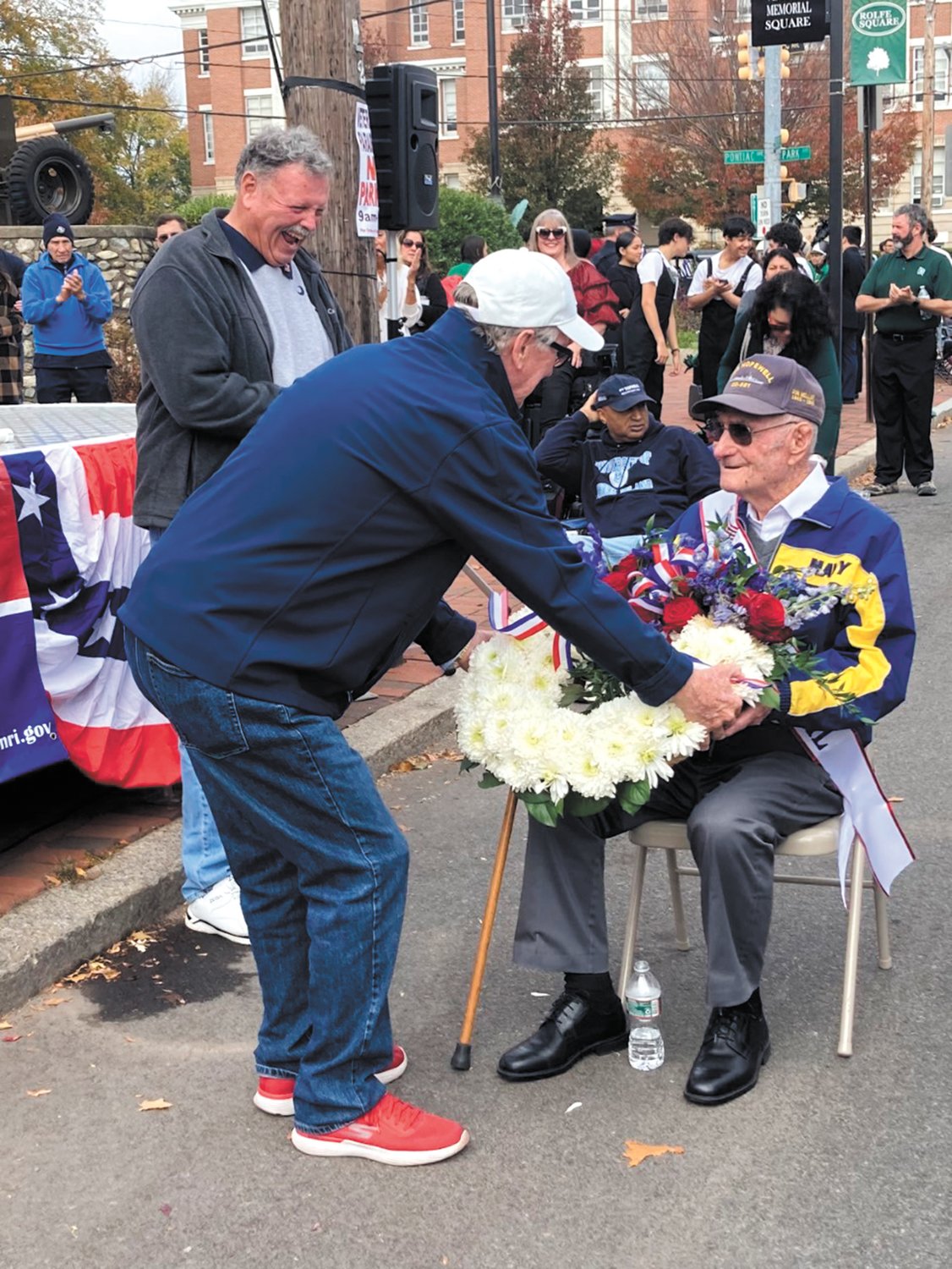SERVICE honored: Mayor Ken Hopkins hands the ceremonial wreath to Grand Marshal Don Mellor.