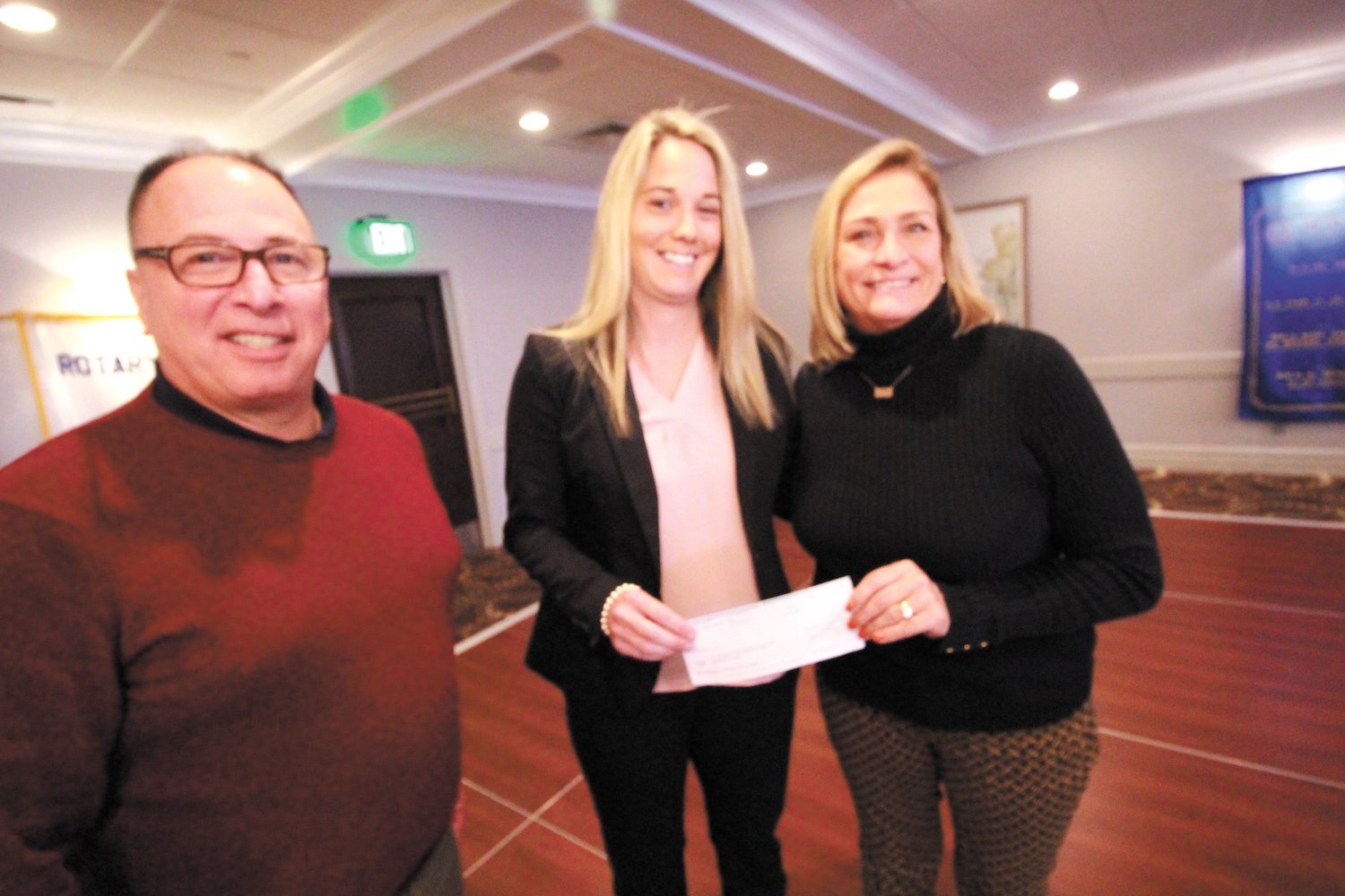 ALL FOR KIDS: Scott Seaback and Janis Constantine, right present Nicole Spirito executive director of VOWS with a $10,000 check that will be used to expand its program. (Warwick Beacon photo)