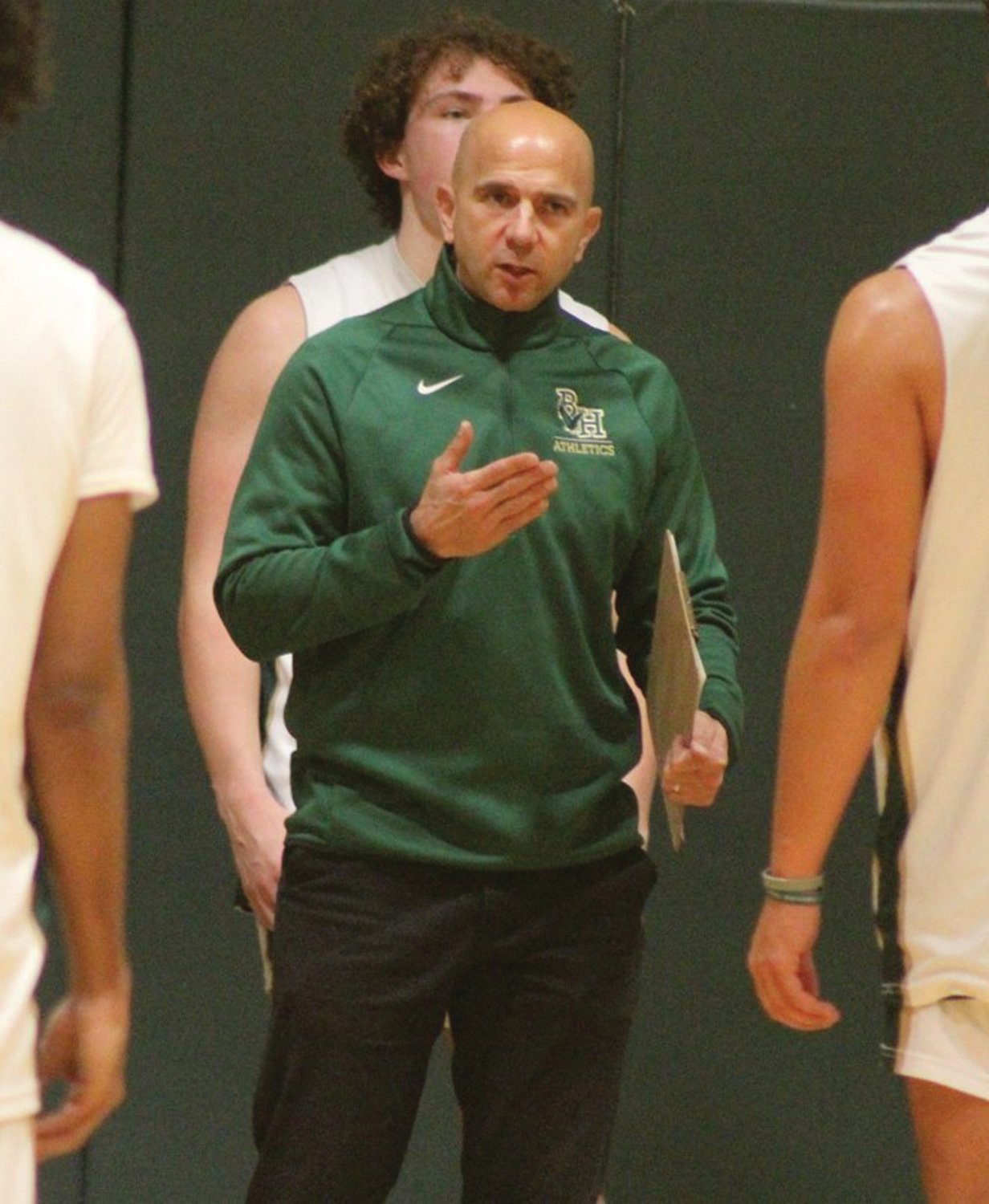 PRACTICE MAKES PERFECT: Hendricken coach Jamal Gomes works with players at practice on Tuesday night in preparation for the upcoming season.