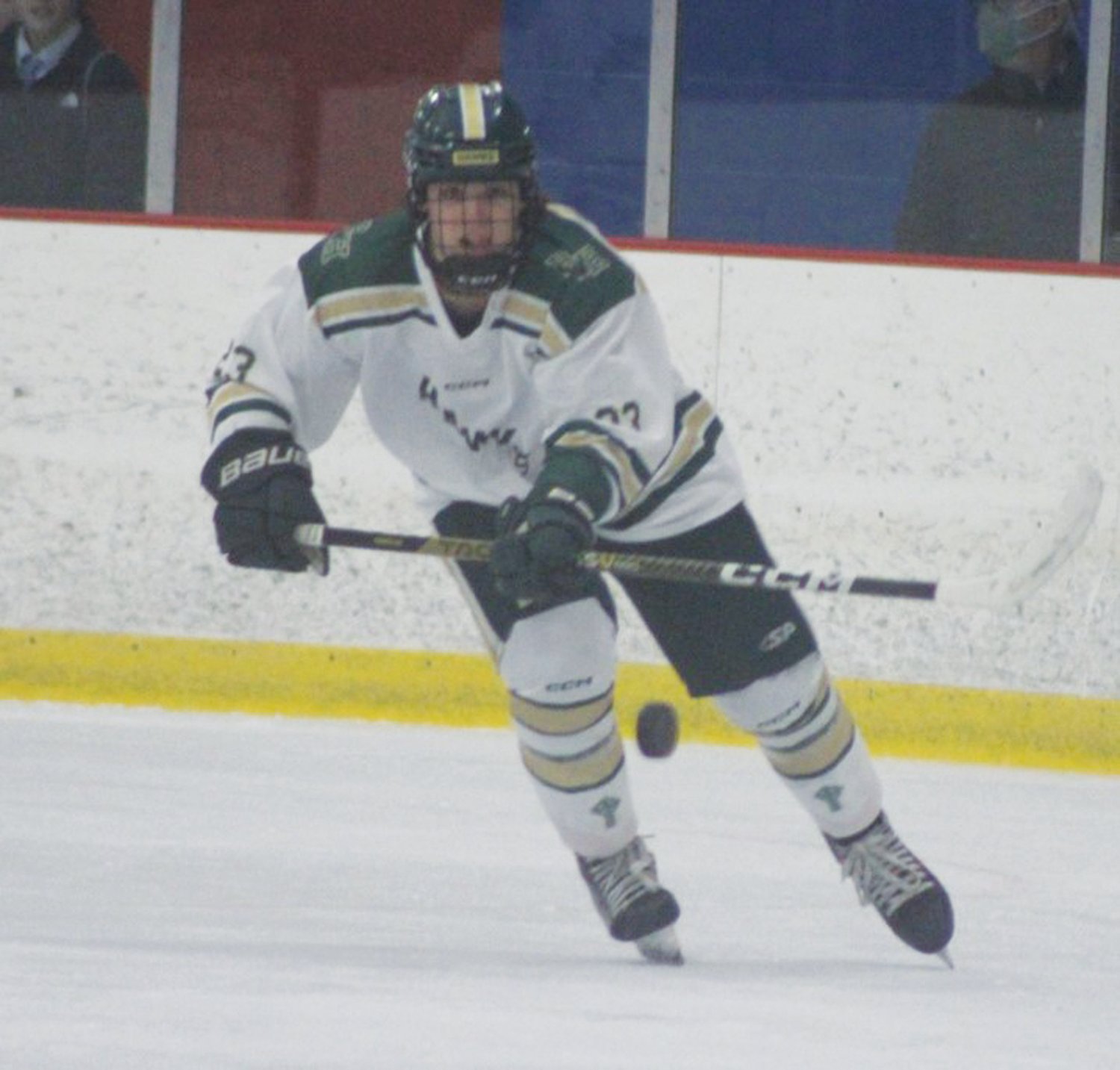 CLEAR THE ZONE: Hendricken’s Frank Tillinghast sends the puck up the ice.