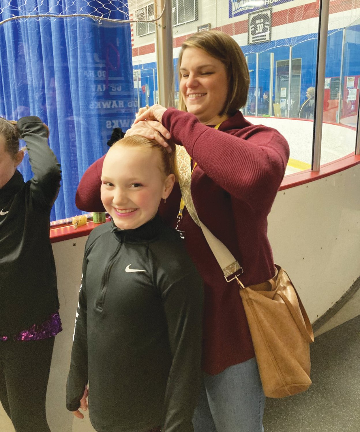 NEW DO: Nine year old Brooklyn Laskowski gets a new hairdo from her mom Bethany in between numbers. Brooklyn is a member of The Snowflakes and skated to Taylor Swifts 2014 song Shake It Off. Mom Bethany herself is a decorated WFS veteran of many years. They live in Warwick and Brooklyn is in the 4th grade at St. Kevin’s.
